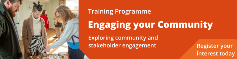 Image of a group of people pointing at a model of a housing development. Image reads: Training programme. Engaging your community Exploring community and stakeholder engagement  Register your interest today