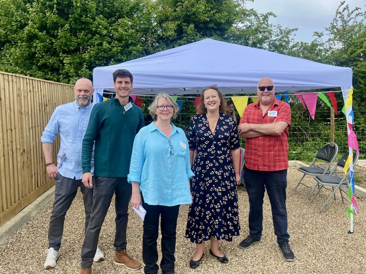 Hook Norton CLT with their Prospective Parliamentary Candidates standing in front of a gazebo at an open day for their almost finished affordable housing development